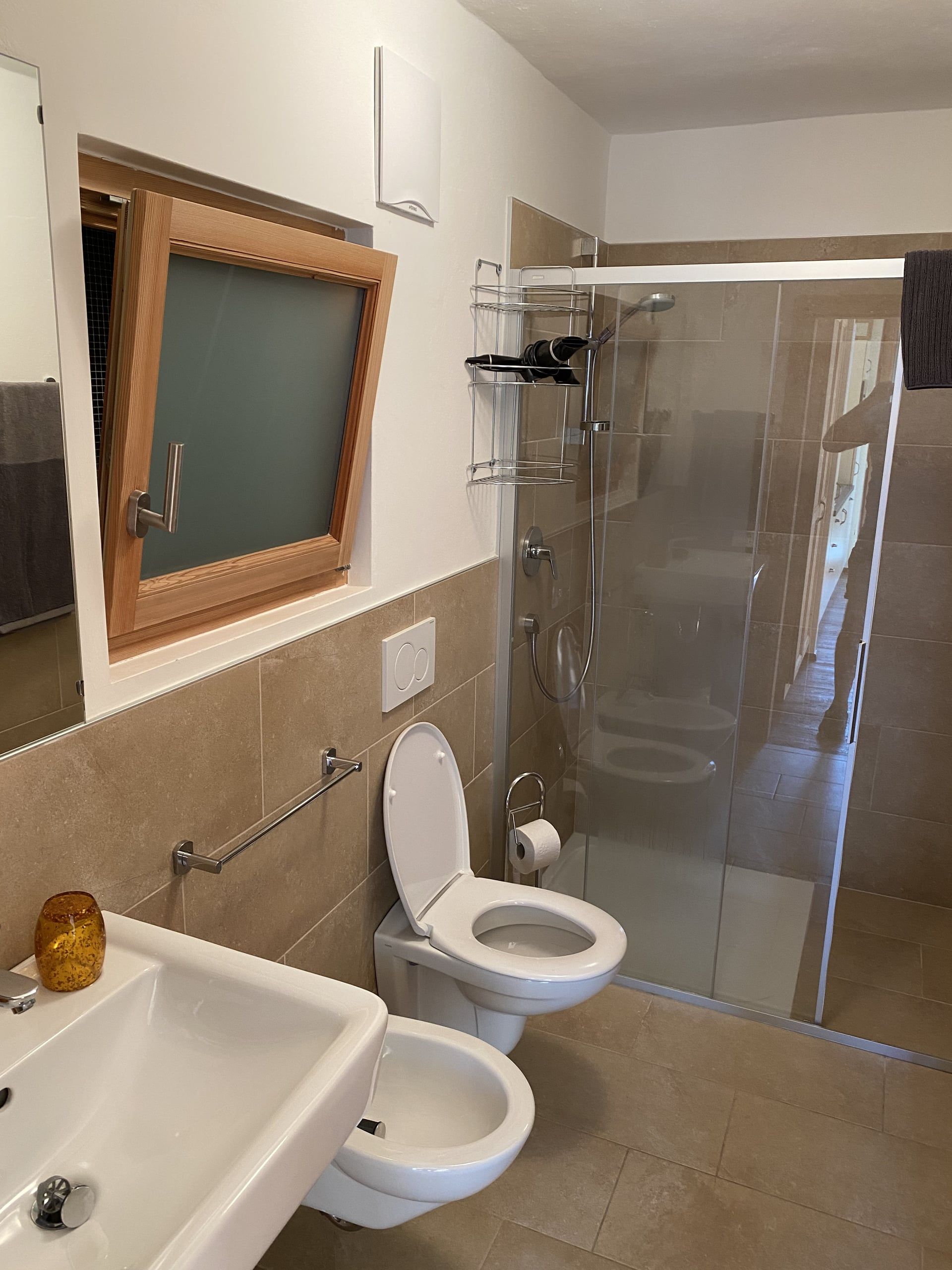 Bathroom in the Buche apartment with glass shower, toilet, bidet and washbasin